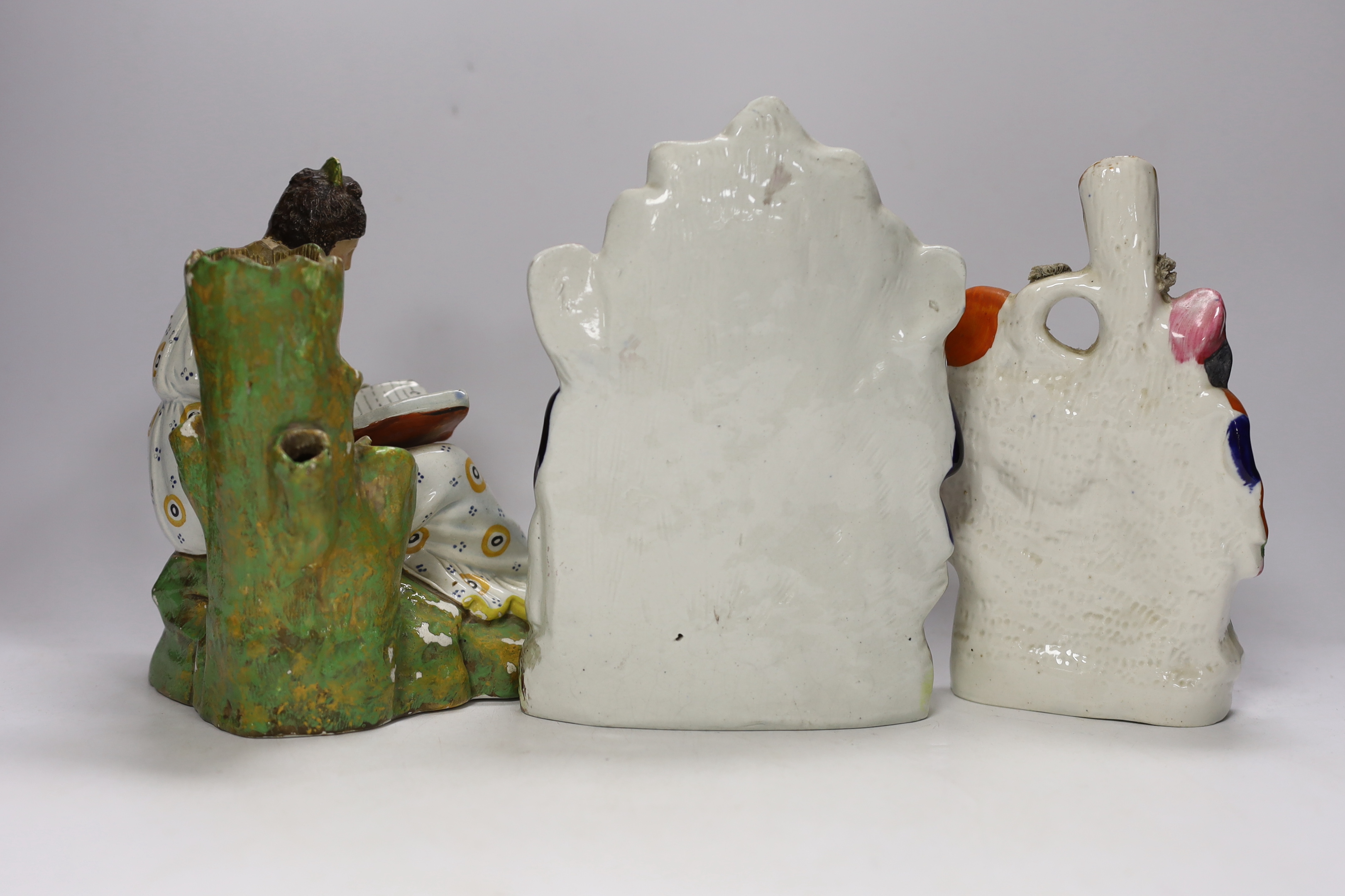 An early 19th century Staffordshire pearlware figure of a seated lady and seven mid 19th century Staffordshire pottery figures